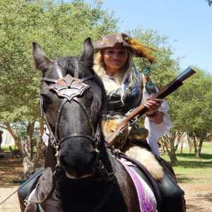 girl on horse with gun